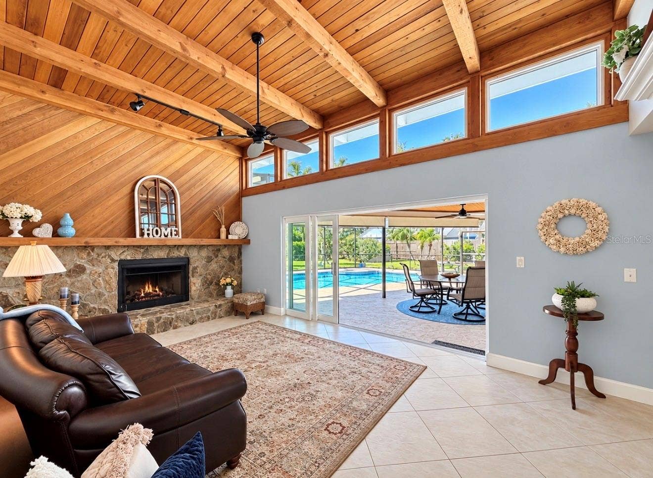 9690 LEEWARD AVENUE, Largo, FL 33773 Family room with natural light and fireplace