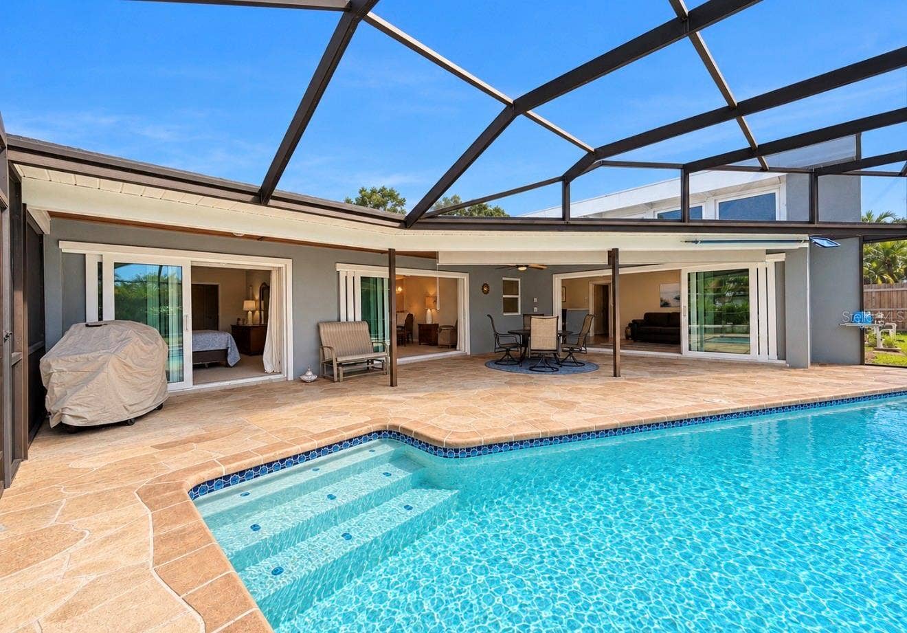 9690 LEEWARD AVENUE, Largo, FL 33773 Screened Enclosed pool looking at the back of home