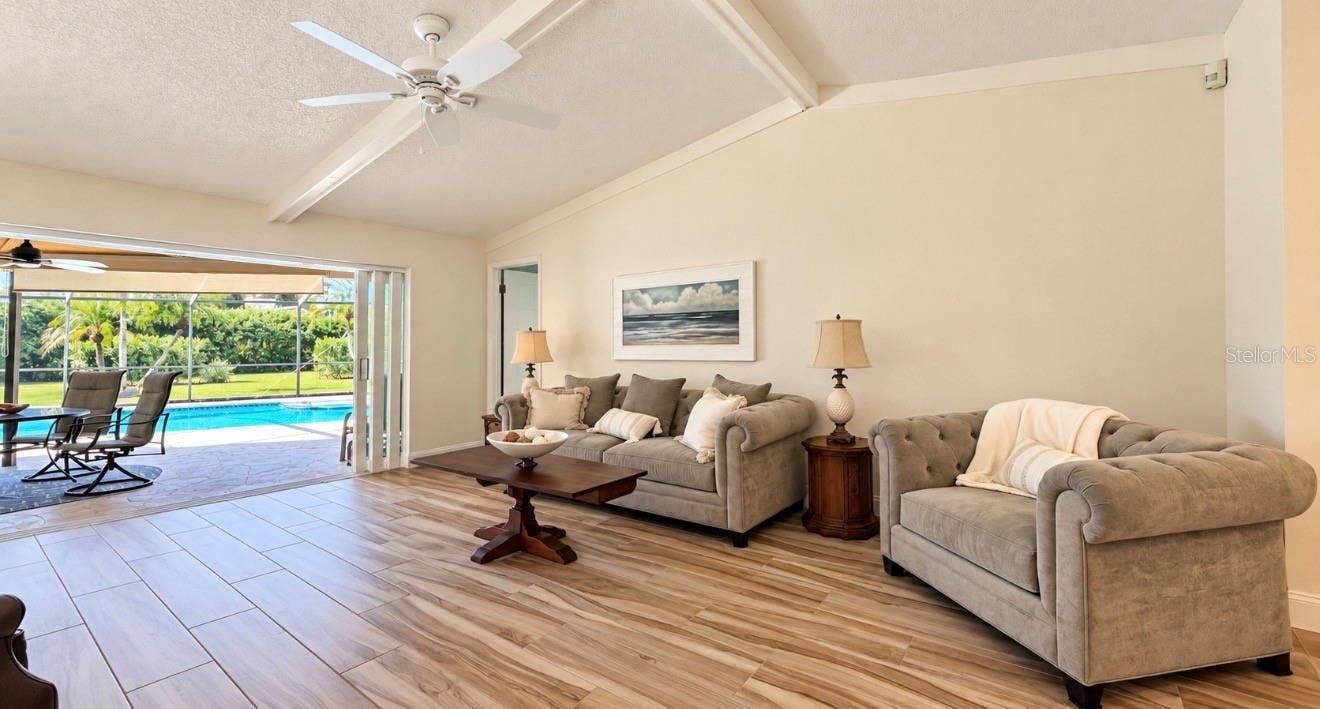 9690 LEEWARD AVENUE, Largo, FL 33773 Living room with 3 pocket sliders