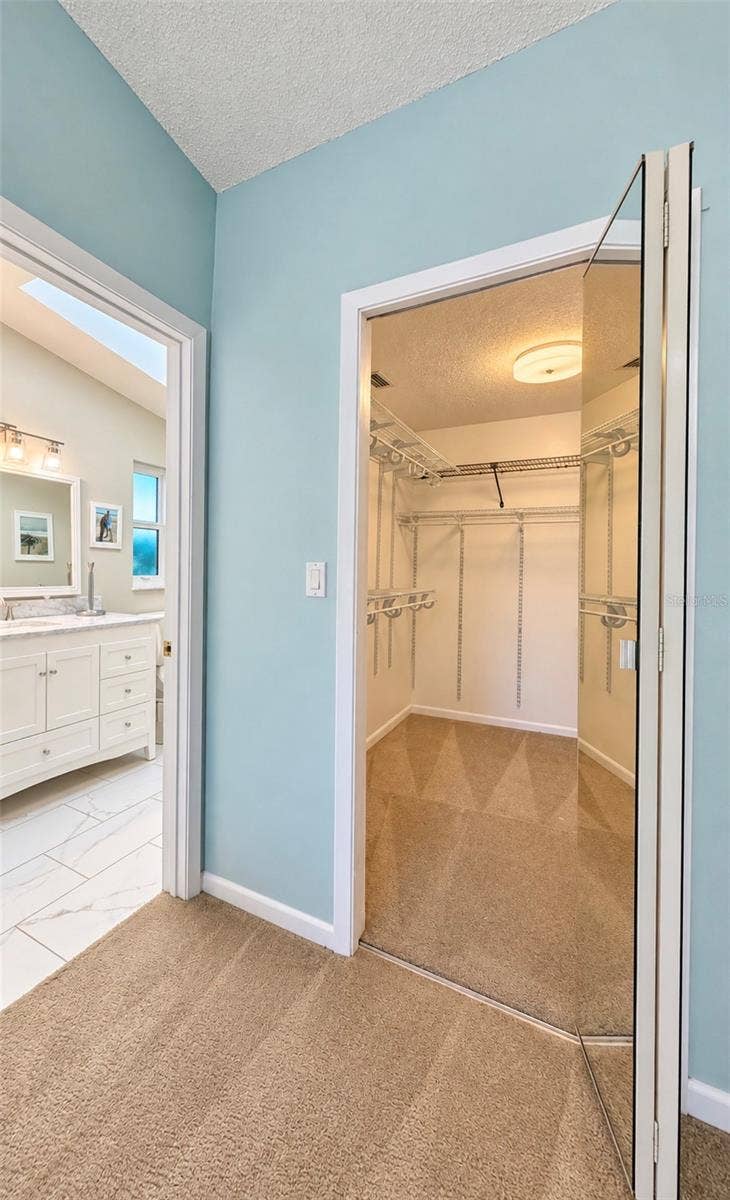 9690 LEEWARD AVENUE, Largo, FL 33773 walk-in closet next to bathroom