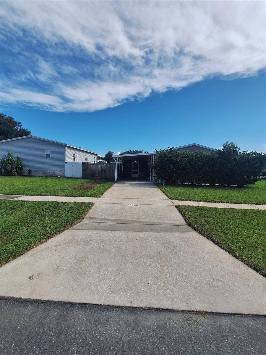 37650 NEWPORT DRIVE, Zephyrhills, FL 33542 Concrete Driveway to Carport