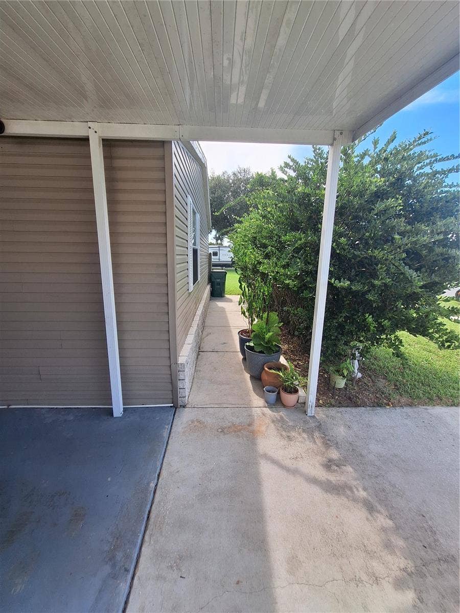 37650 NEWPORT DRIVE, Zephyrhills, FL 33542 Walkway behind the front landscaping to the side and bank yard.