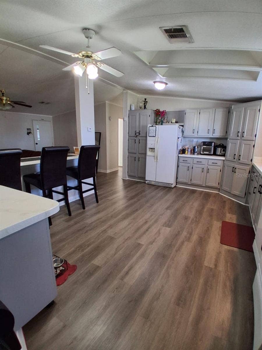 37650 NEWPORT DRIVE, Zephyrhills, FL 33542 Shows kitchen bar area that looks into living room. To the very left of this photoshows a moveable kitchen Island! What convenience!To