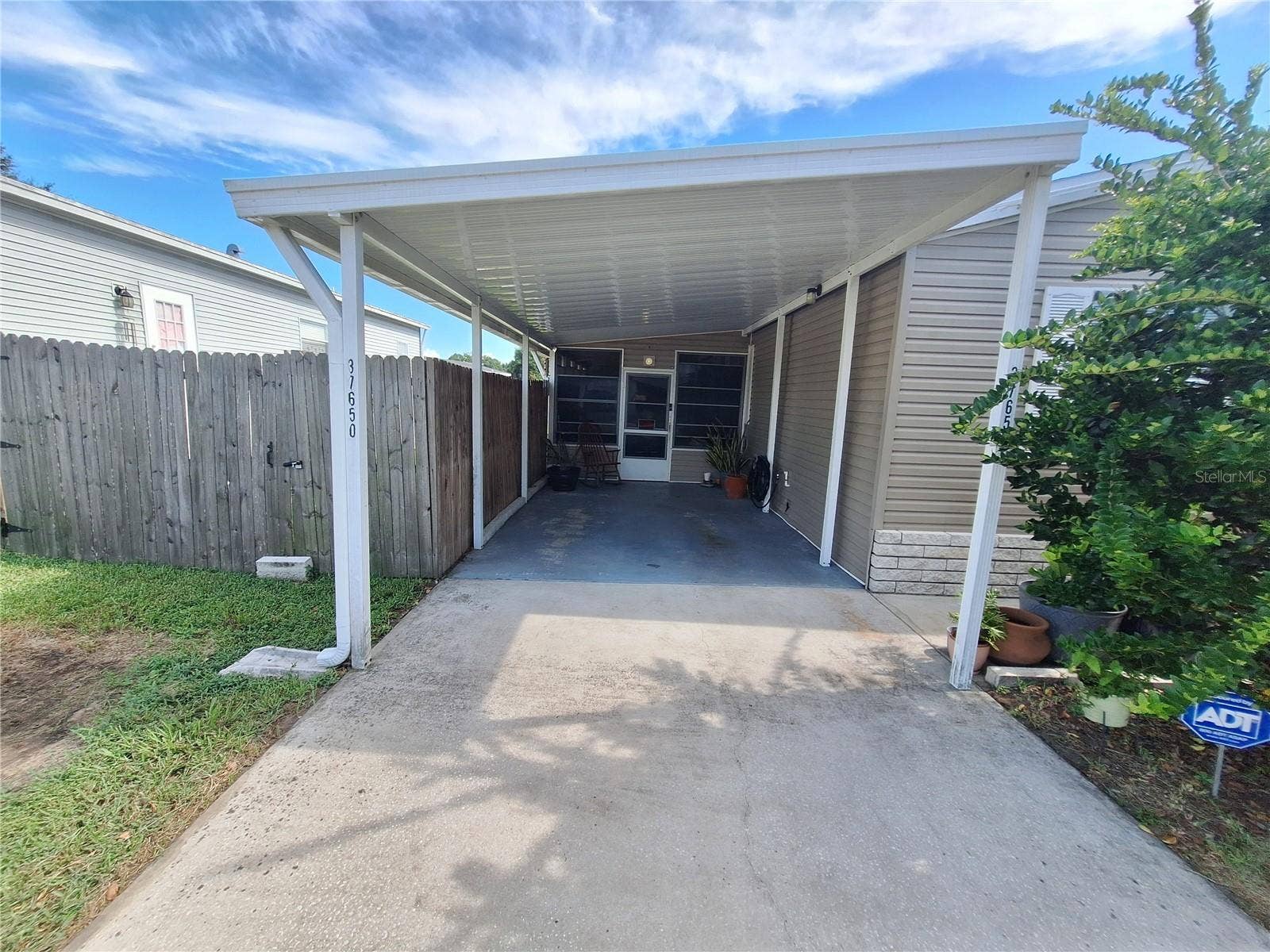37650 NEWPORT DRIVE, Zephyrhills, FL 33542 The door in the carport leads into the Florida Room.