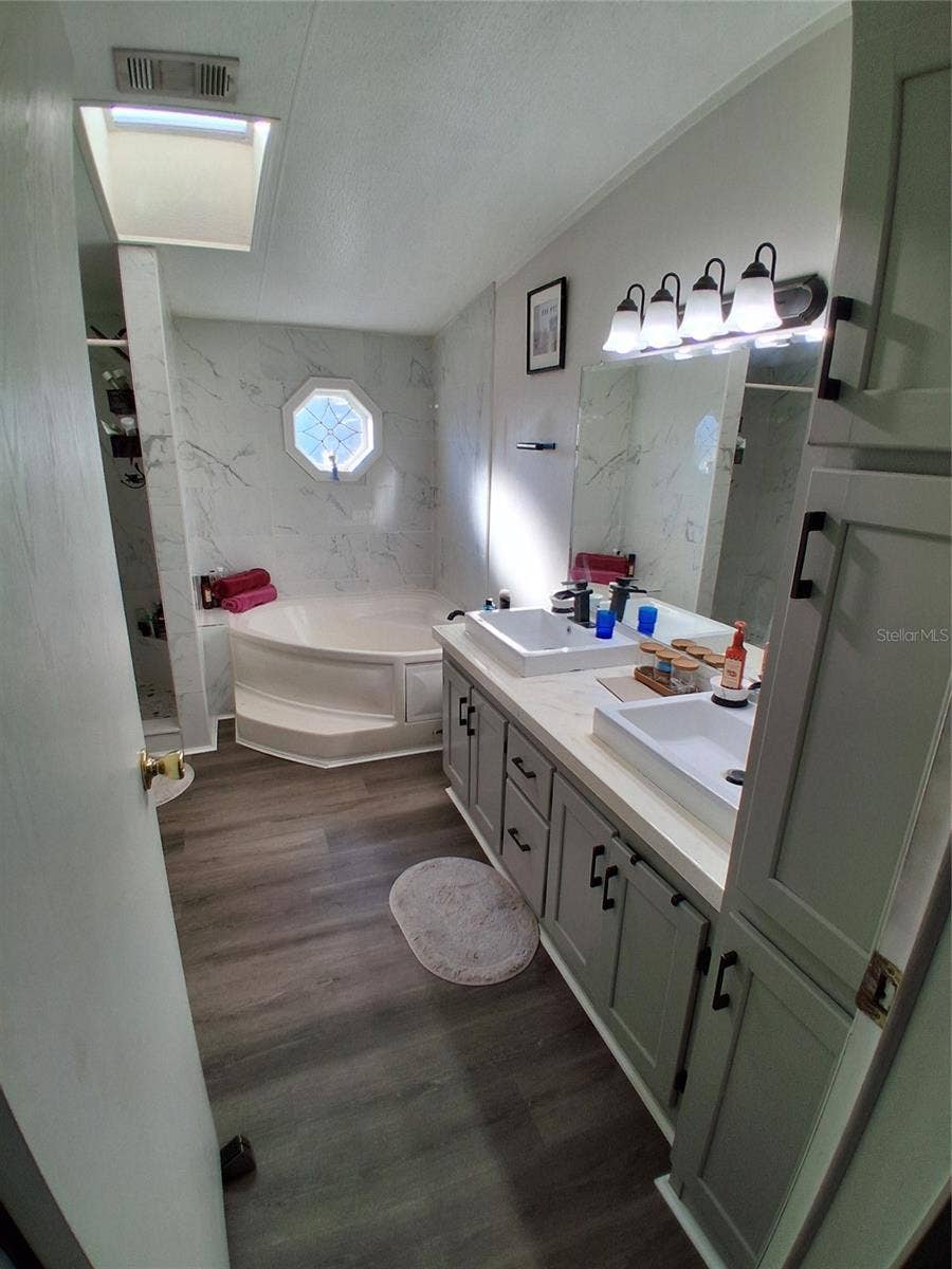 37650 NEWPORT DRIVE, Zephyrhills, FL 33542 Private primary bathroom shows the recent updates. Loads of cabinets.