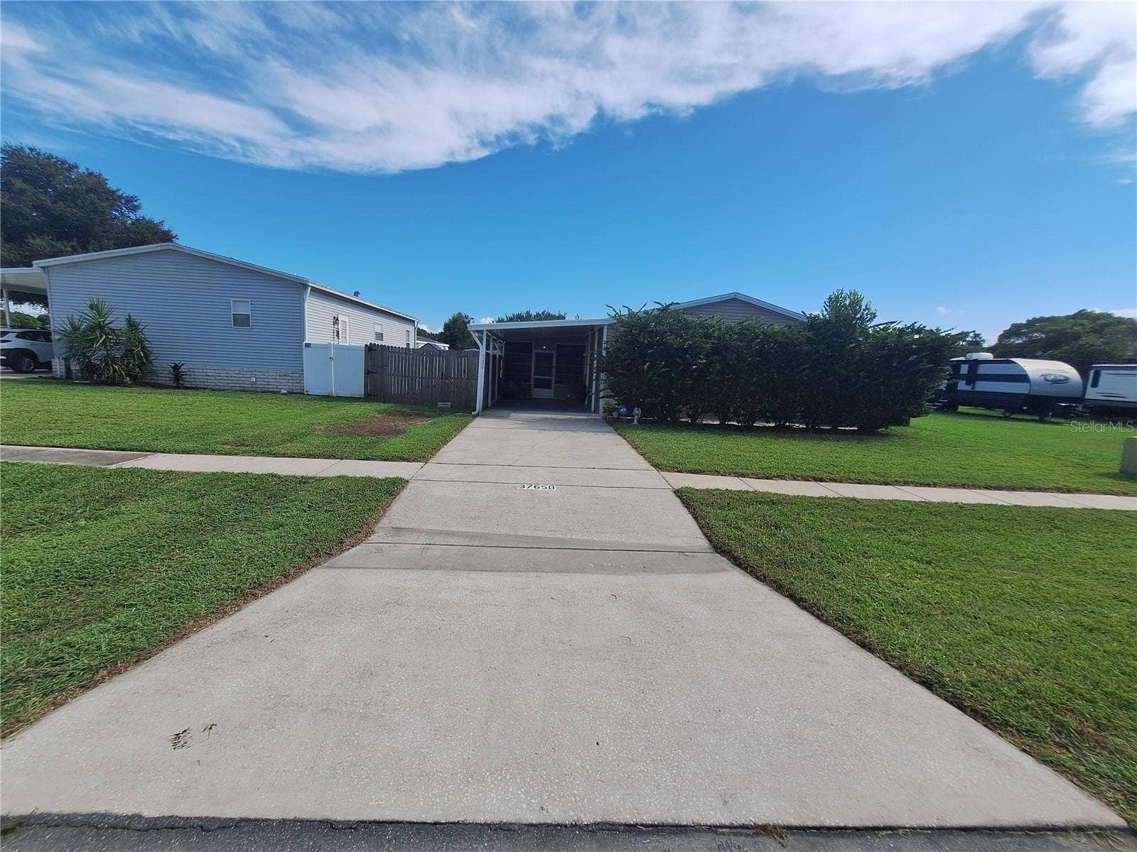 37650 NEWPORT DRIVE, Zephyrhills, FL 33542 Driveway to carport