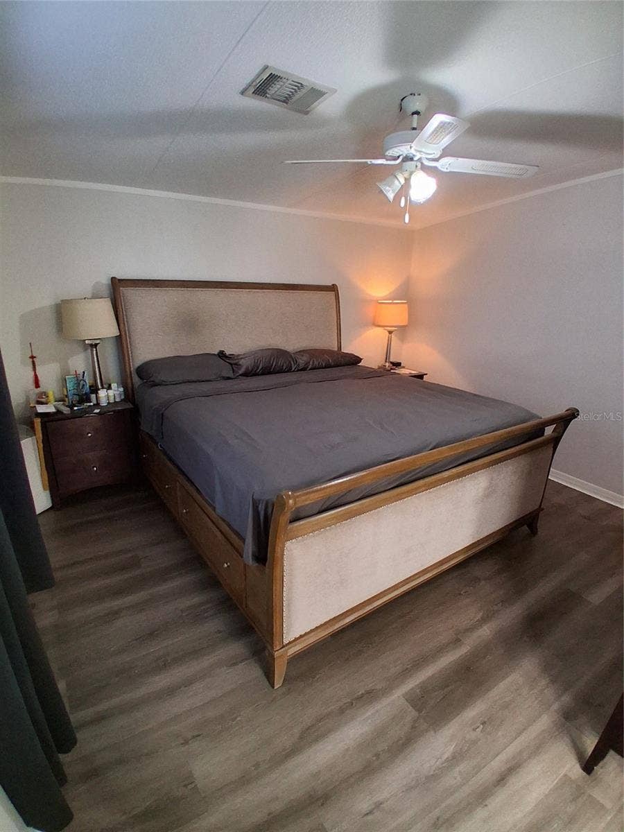 37650 NEWPORT DRIVE, Zephyrhills, FL 33542 Primary bedroom showing the end tables on each side of the king size bed.