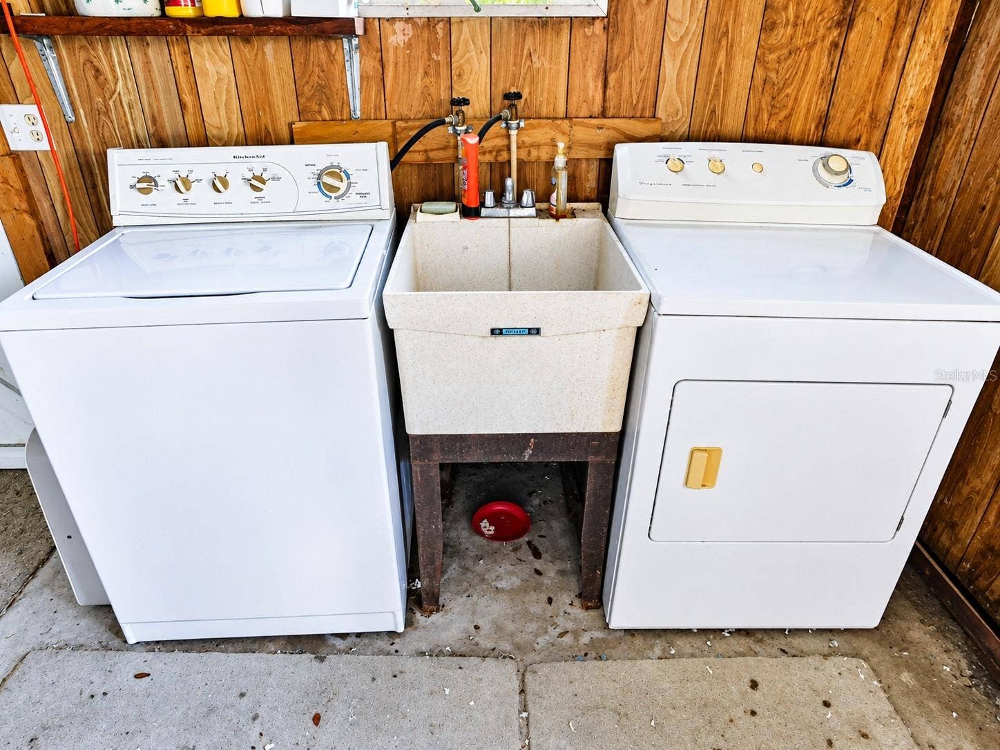 4611 OLIVE DRIVE, Zephyrhills, FL 33542 Laundry is located in the shed off screen room.