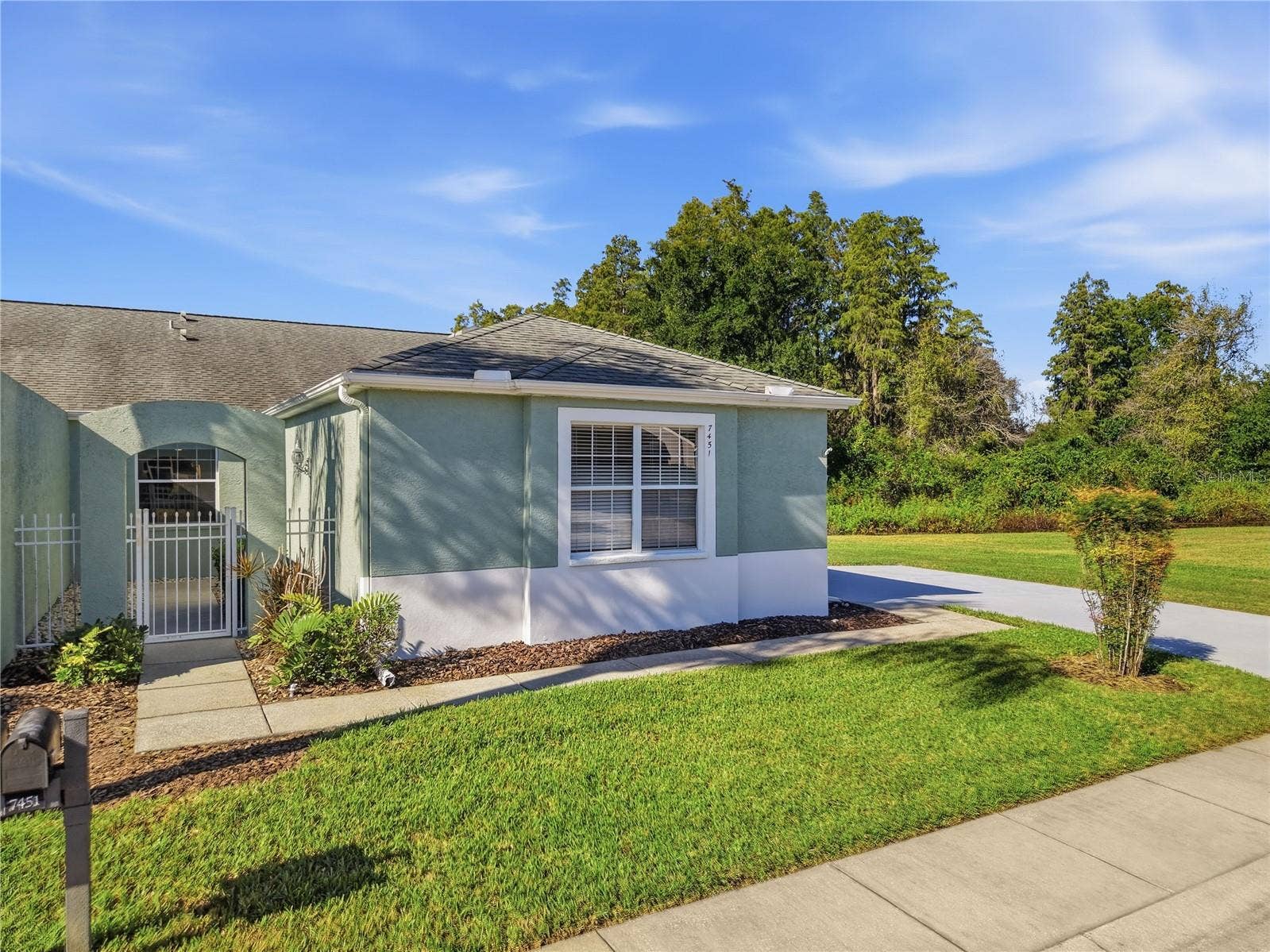 This unit is an end unit with lots of green space to the right of it