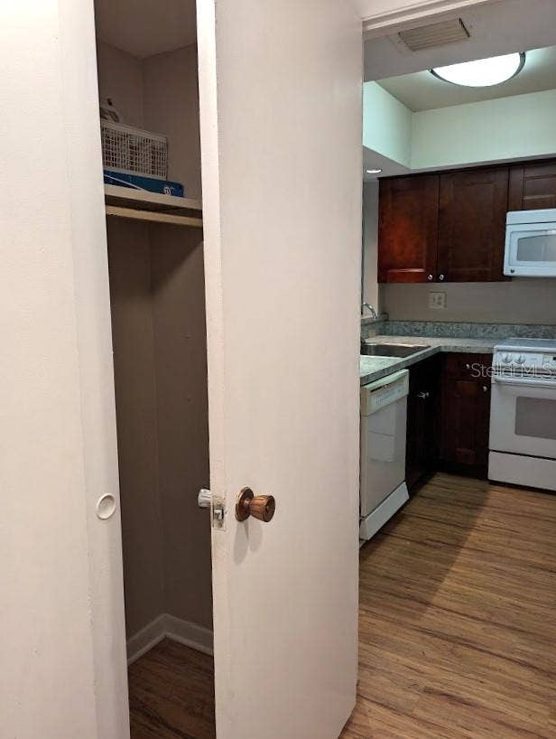 Connecting laundry area has closet space with slider doors