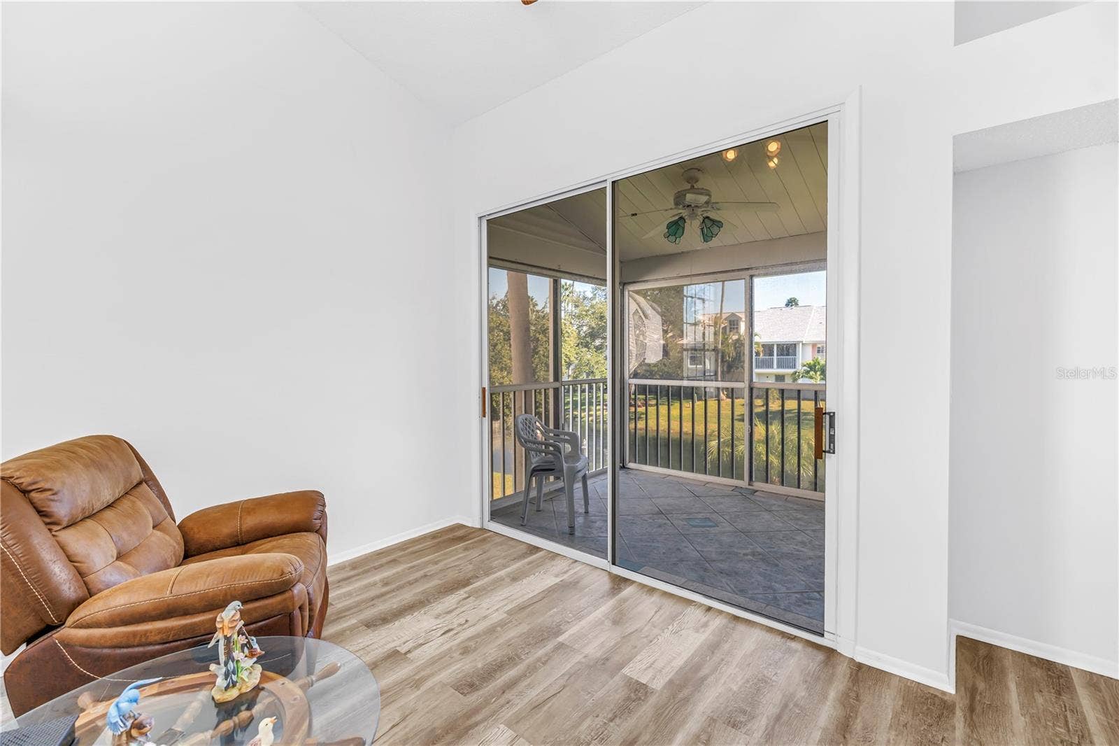 159 SUN ISLE CIR, Treasure Island, FL 33706 Looking out to screened in patio to lake view