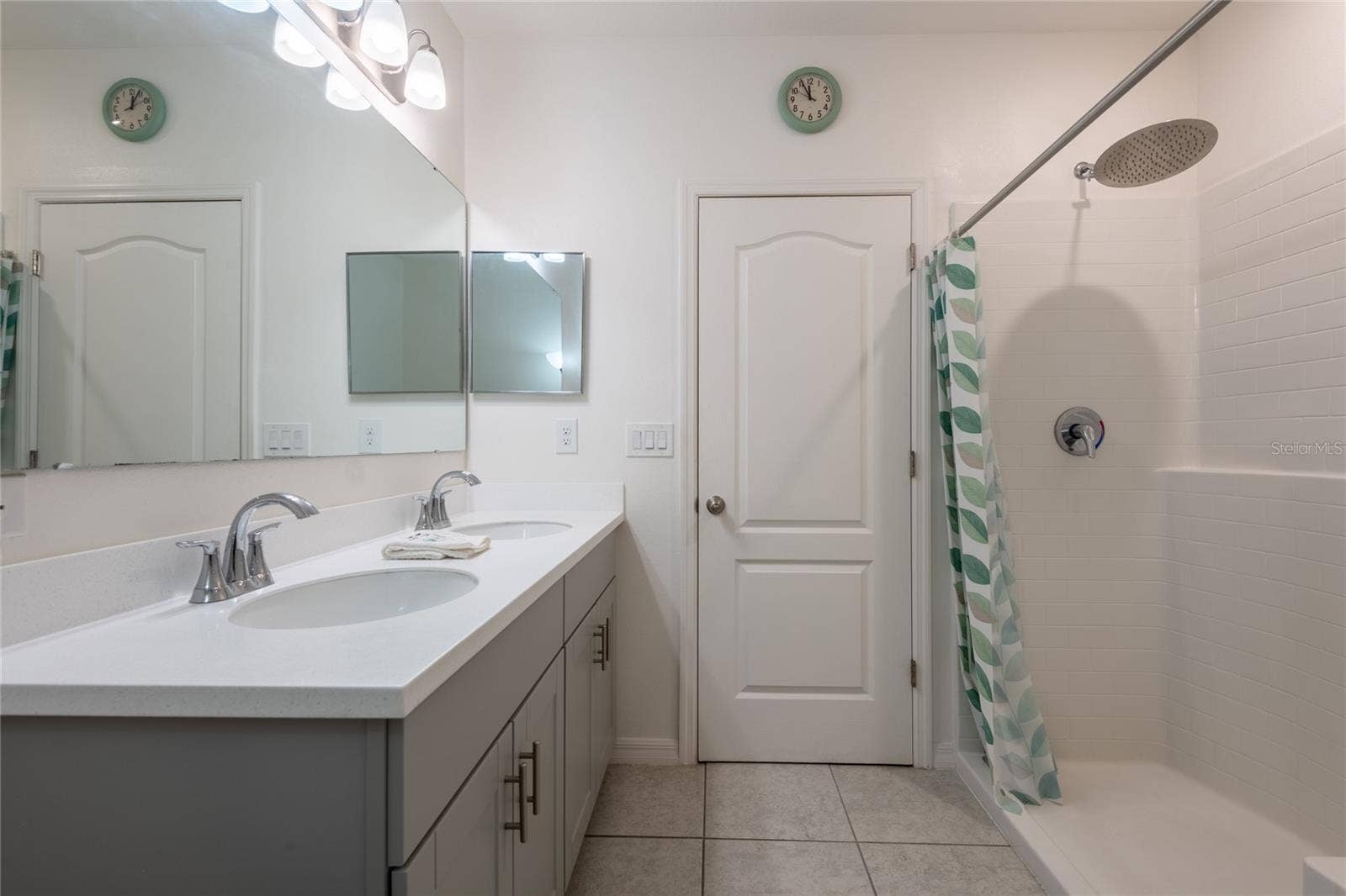 13459 BANYAN ROAD, Spring Hill, FL 34609 Primary bathroom with walk in shower and double sinks. Shaker cabinets and quartz counter tops.