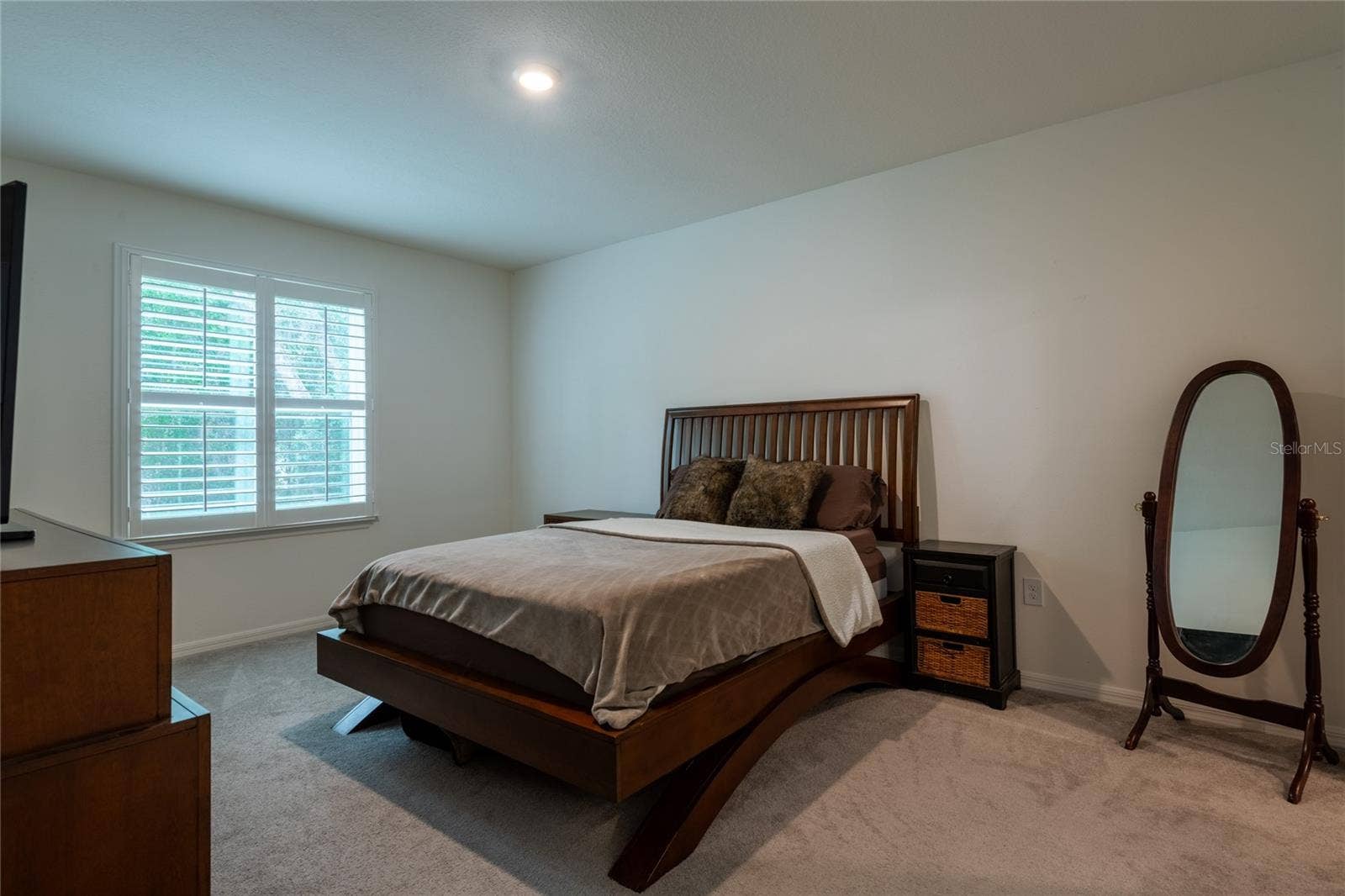 13459 BANYAN ROAD, Spring Hill, FL 34609 Primary bedroom with plantation shutters.