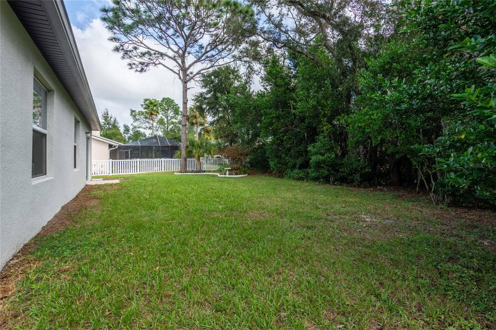 13459 BANYAN ROAD, Spring Hill, FL 34609 Large backyard bordered with trees for privacy.