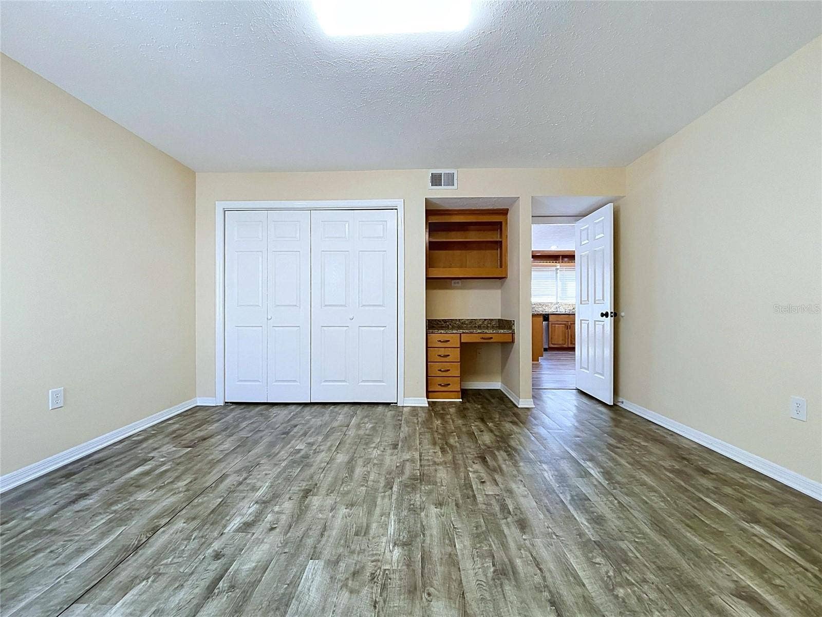 main floor bedroom with bathroom and laundry