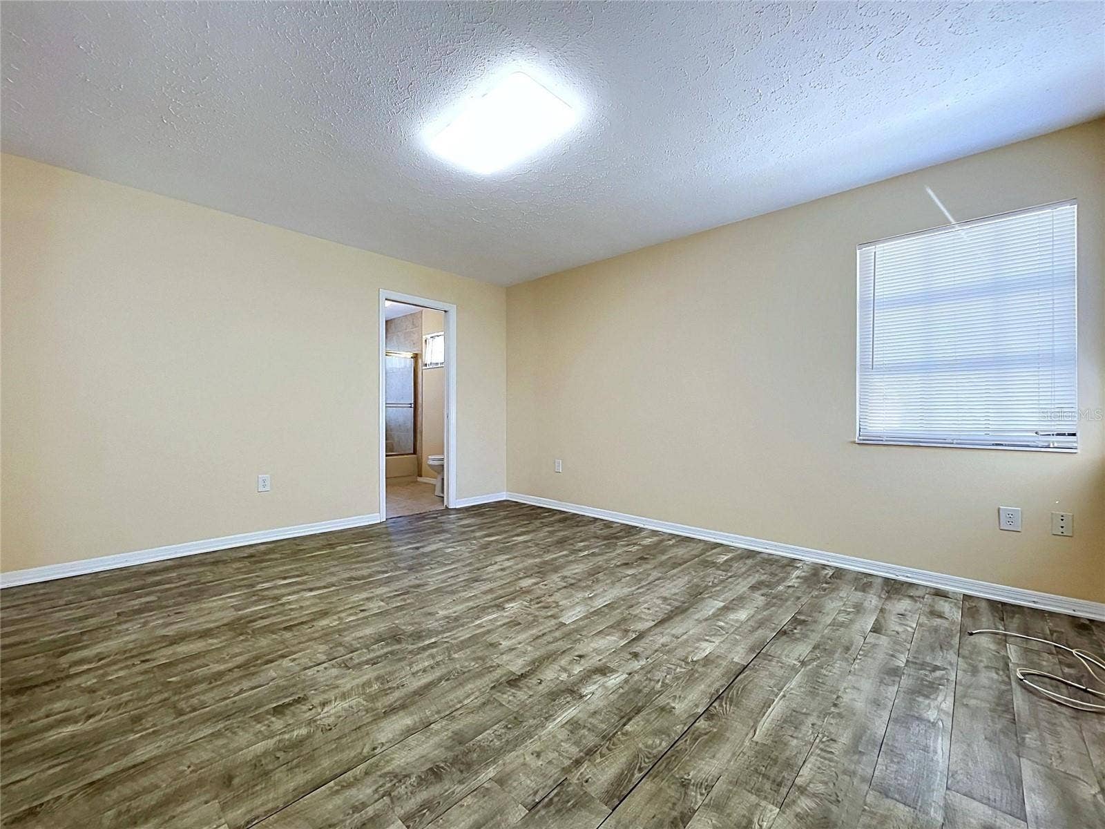 main floor bedroom with bathroom and laundry