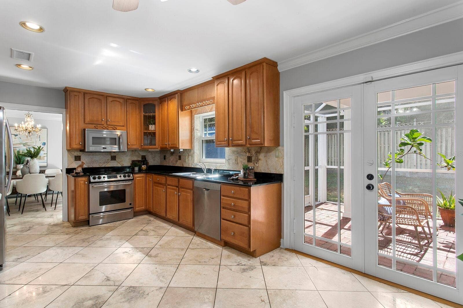 2930 W BAYSHORE COURT, Tampa, FL 33611 The closed lanai is just to the right of the kitchen and you can see the formal dining room.