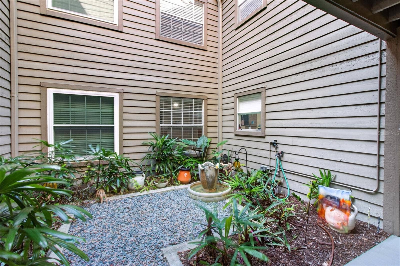 2500 WINDING CREEK BOULEVARD, #I106, Clearwater, FL 33761 Courtyard just before front door. Kitchen window & bedroom 2 face this.