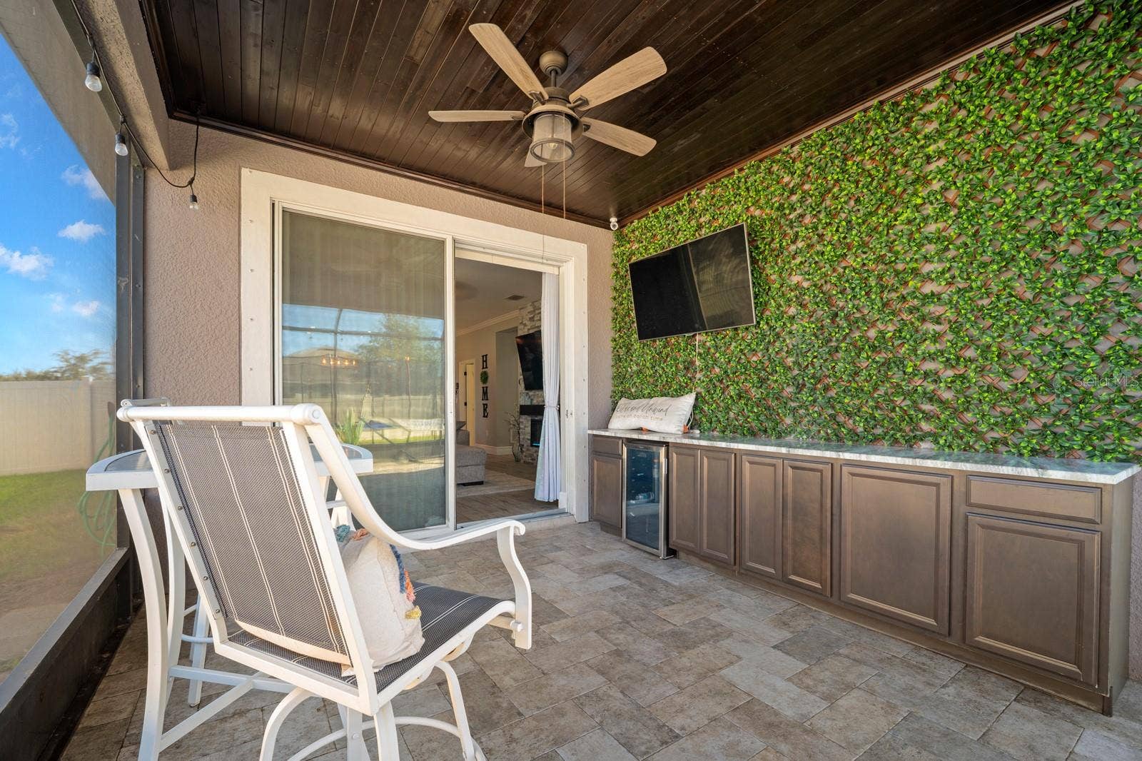 10654 PLANER PICKET DRIVE, Riverview, FL 33569 Covered lanai with outdoor kitchen, ceiling fan and mounted TV