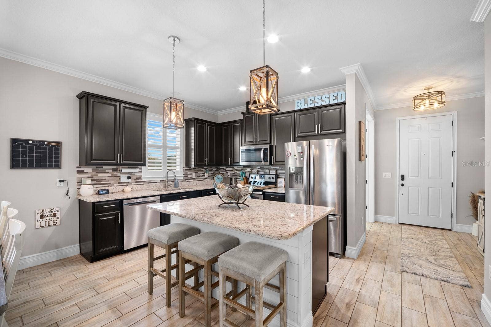 10654 PLANER PICKET DRIVE, Riverview, FL 33569 Kitchen with large granite island, breakfast bar seating and stainless appliances