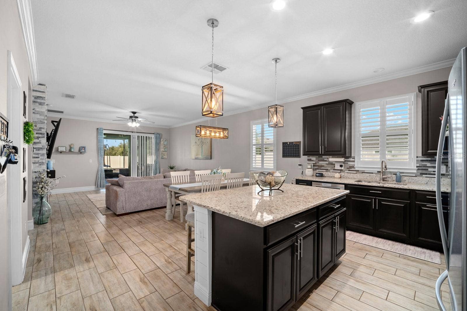 10654 PLANER PICKET DRIVE, Riverview, FL 33569 Kitchen island overlooking the open family room and sliders to the lanai