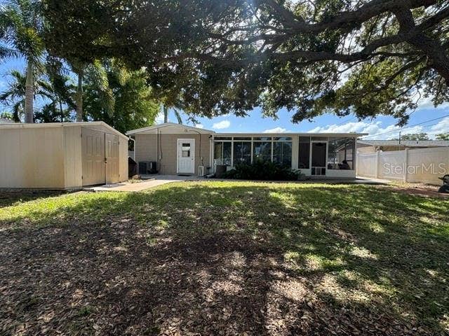 5717 15TH AVENUE N, St Petersburg, FL 33710 Rear view of backyard, residence, and storage shed
