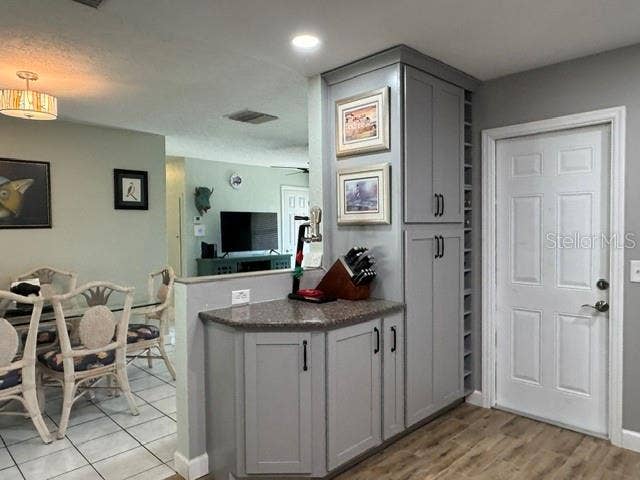 5717 15TH AVENUE N, St Petersburg, FL 33710 Kitchen view from sink showing garage entry, additional cabinents, and wine rack
