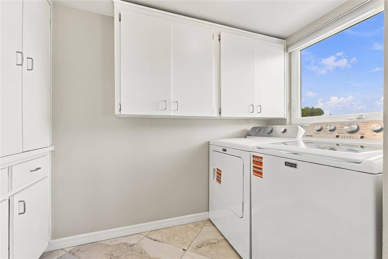 2228 SWEDISH DRIVE, #22, Clearwater, FL 33763 Inside laundry room with loads of storage cabinets