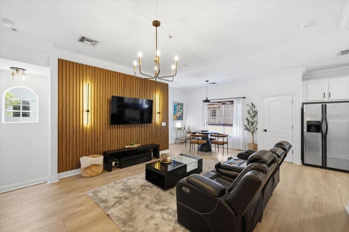Fluted Ribbon Maple Accent Wall with Sconce LED Lighting and LVP Flooring throughout!