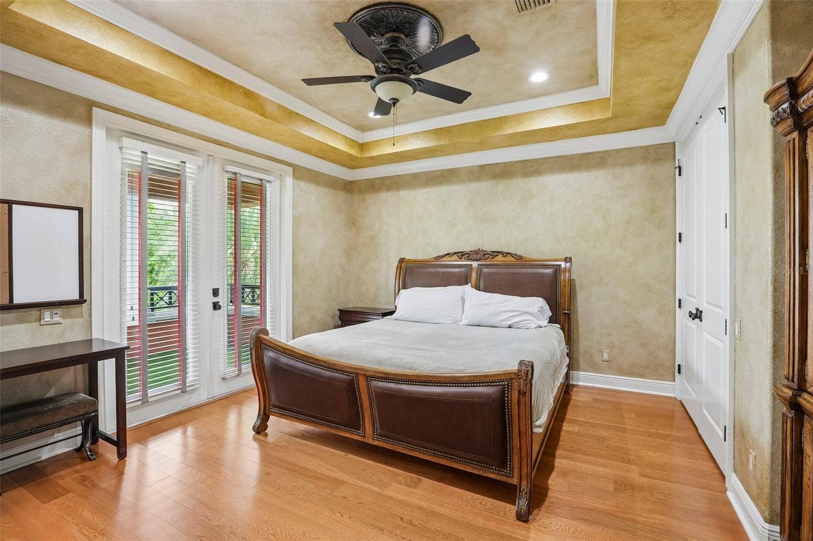 Upstairs bedroom with en-suite bath and balcony access.