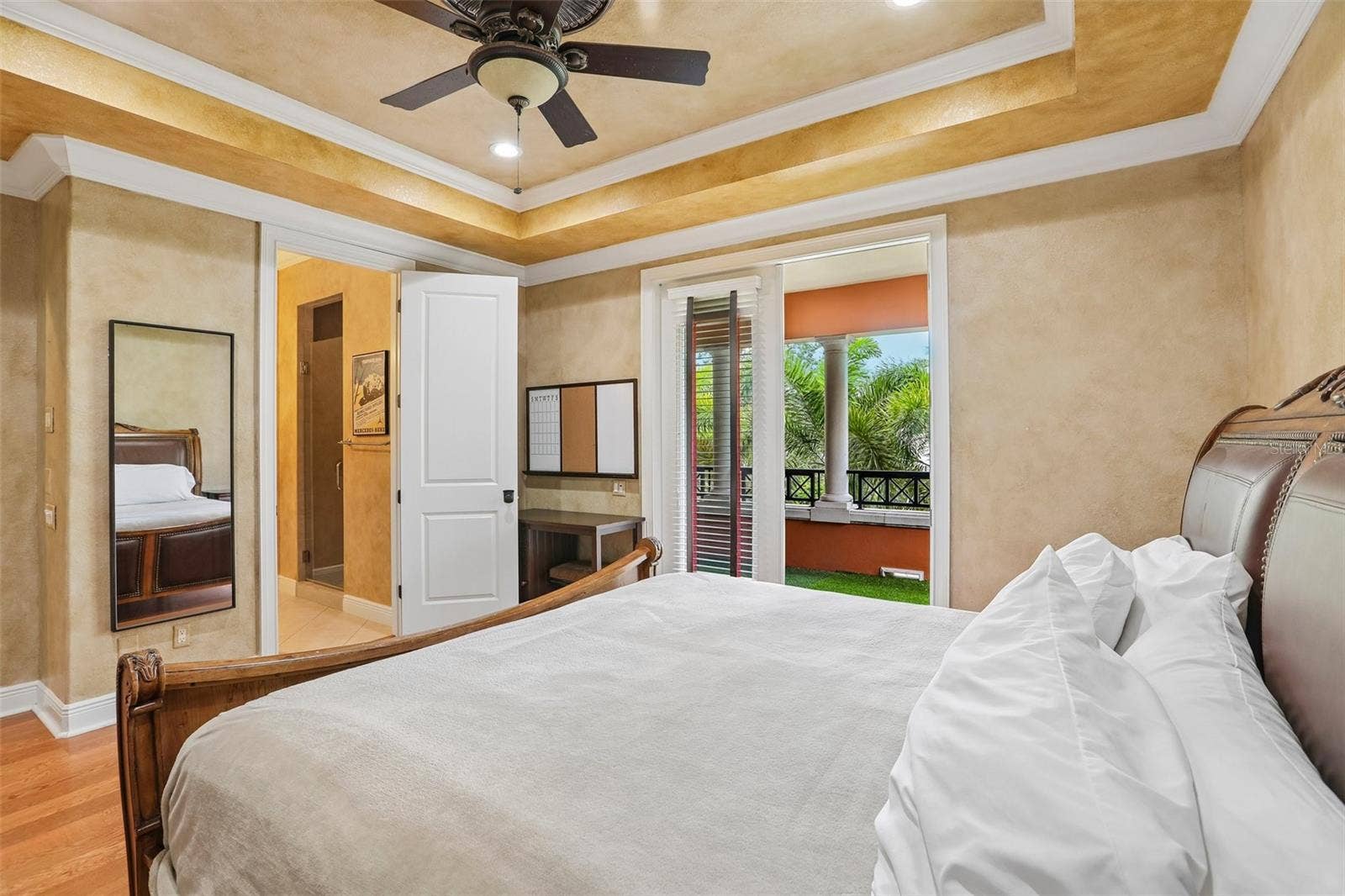 Upstairs bedroom with en-suite bath and balcony access.