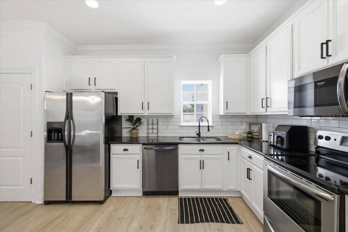 Kitchen with granite counter tops, new sink, and stainless steel appliances