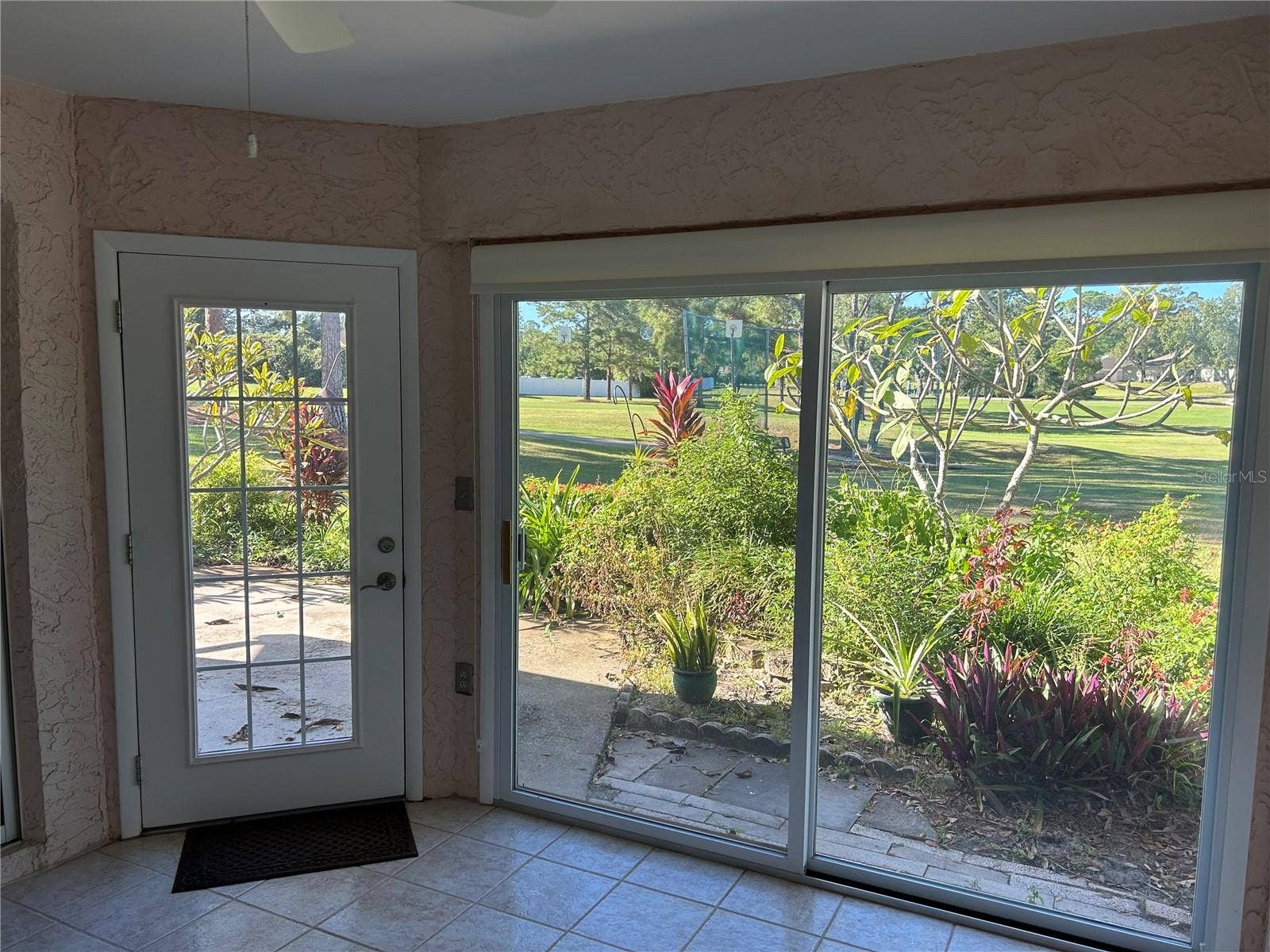1130 RUSTLEWOOD COURT, Palm Harbor, FL 34684 Sunroom door to outside patio