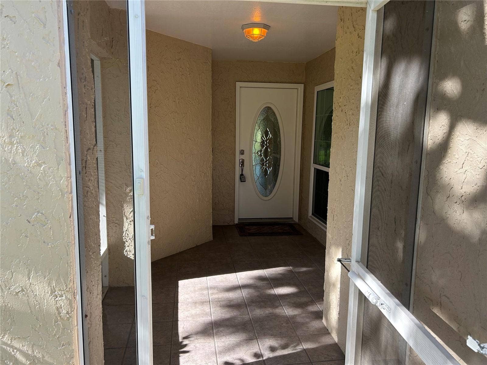 1130 RUSTLEWOOD COURT, Palm Harbor, FL 34684 Front Porch screened Foyer