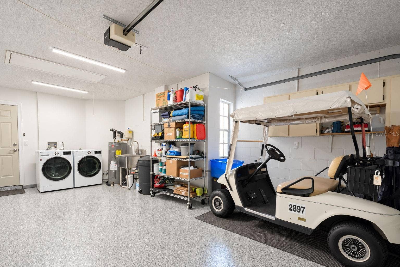 1146 RUSTLEWOOD COURT, Palm Harbor, FL 34684 1.5 car garage with beautifully epoxyed flooring, and newer 2024 "smart" washer/dry, & convenient utility sink~