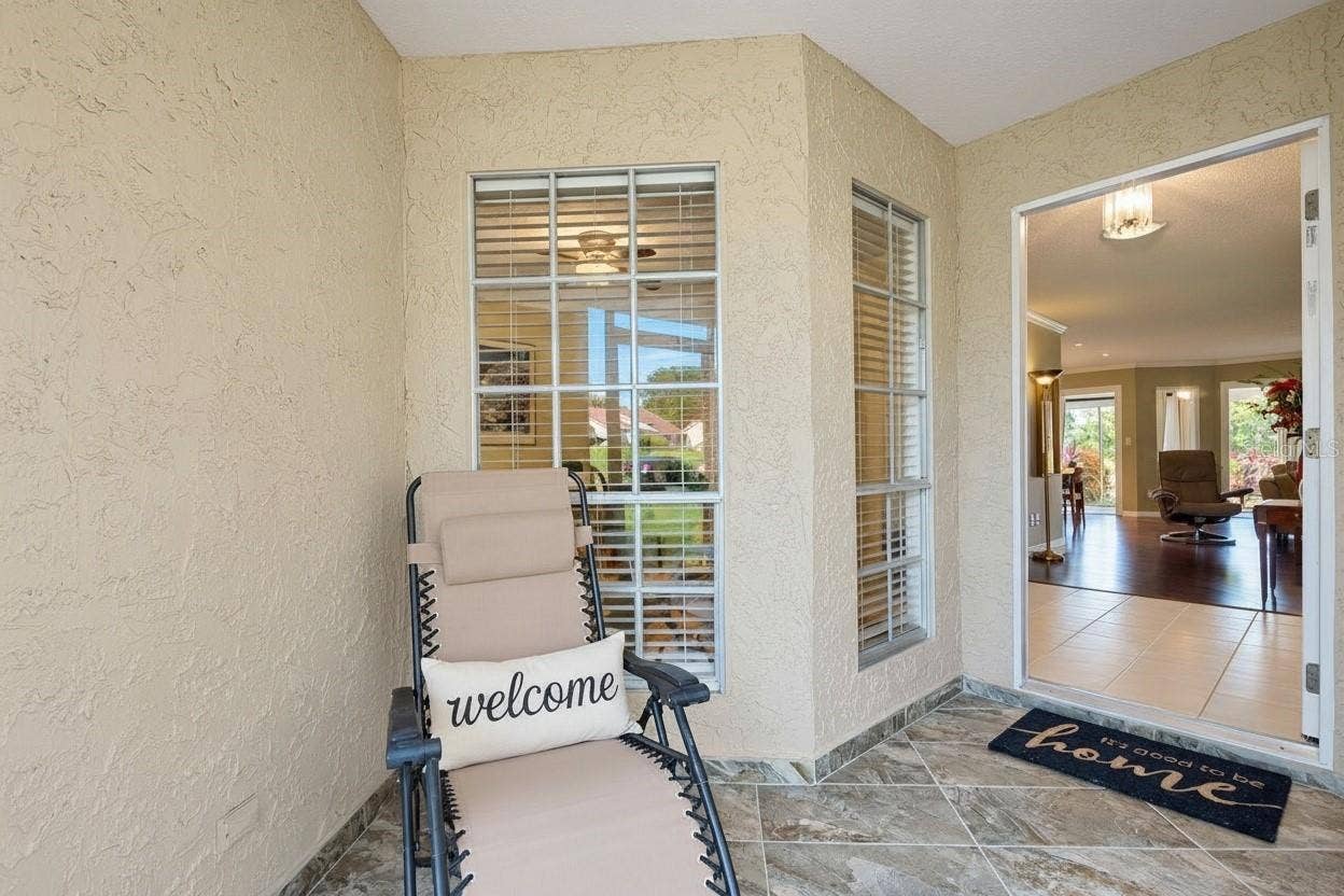 1146 RUSTLEWOOD COURT, Palm Harbor, FL 34684 Welcoming front screened porch entry with beautiful tiled flooring~