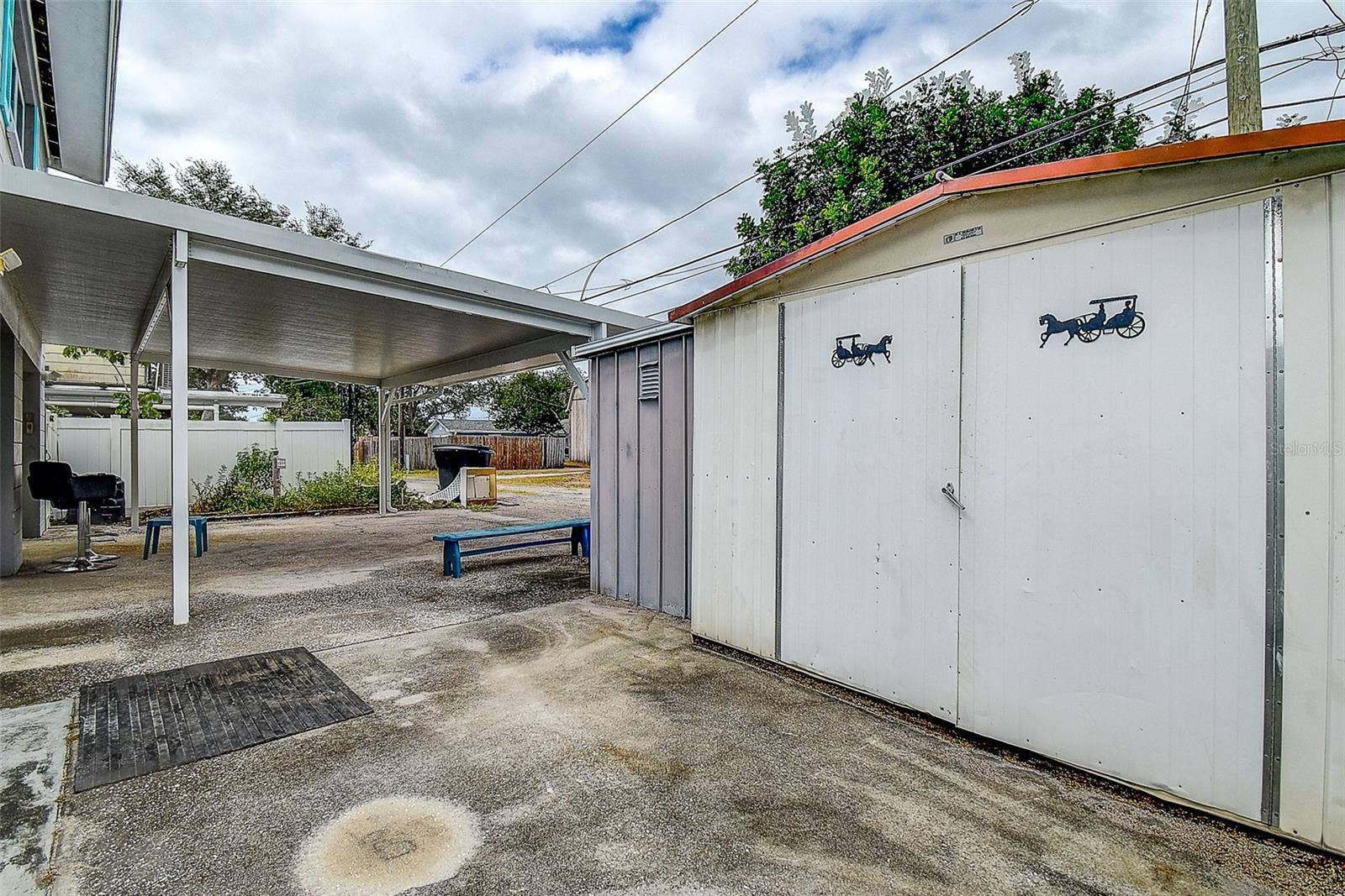 Rear Carport With 2 Storage Sheds