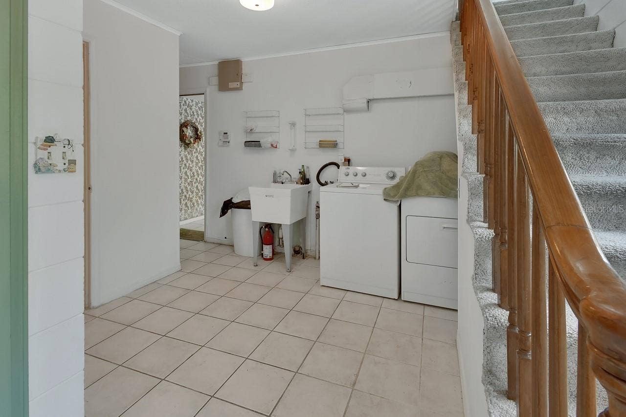 1440 ARROYO VISTA DRIVE, Deland, FL 32724 Laundry looking to the kitchen, also an exit to the pool, 1/2 bath and garage