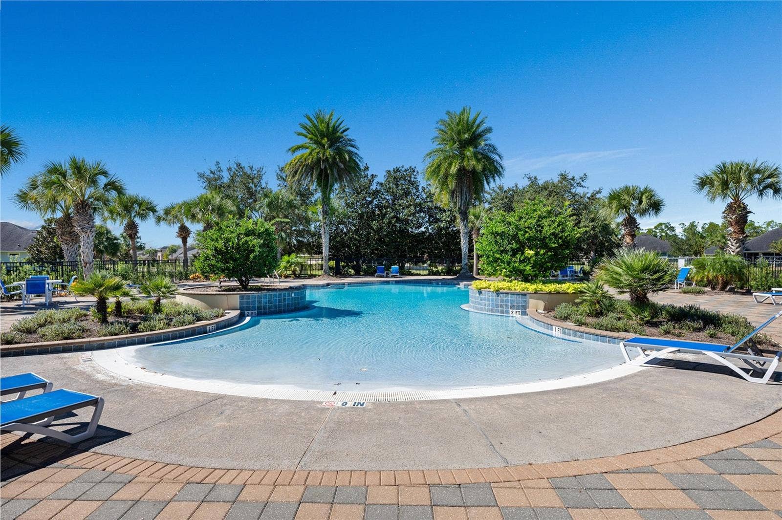 372 CHELSEA PLACE AVENUE, Ormond Beach, FL 32174 Community pool, lounge chairs await