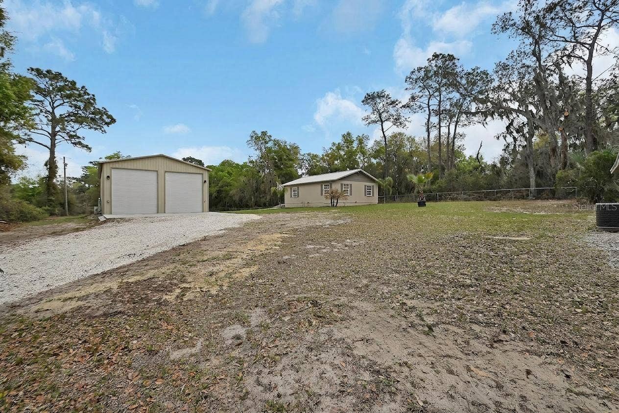 4611 GRAND AVENUE, De Leon Springs, FL 32130 Shot of Outbuilding and Home #2