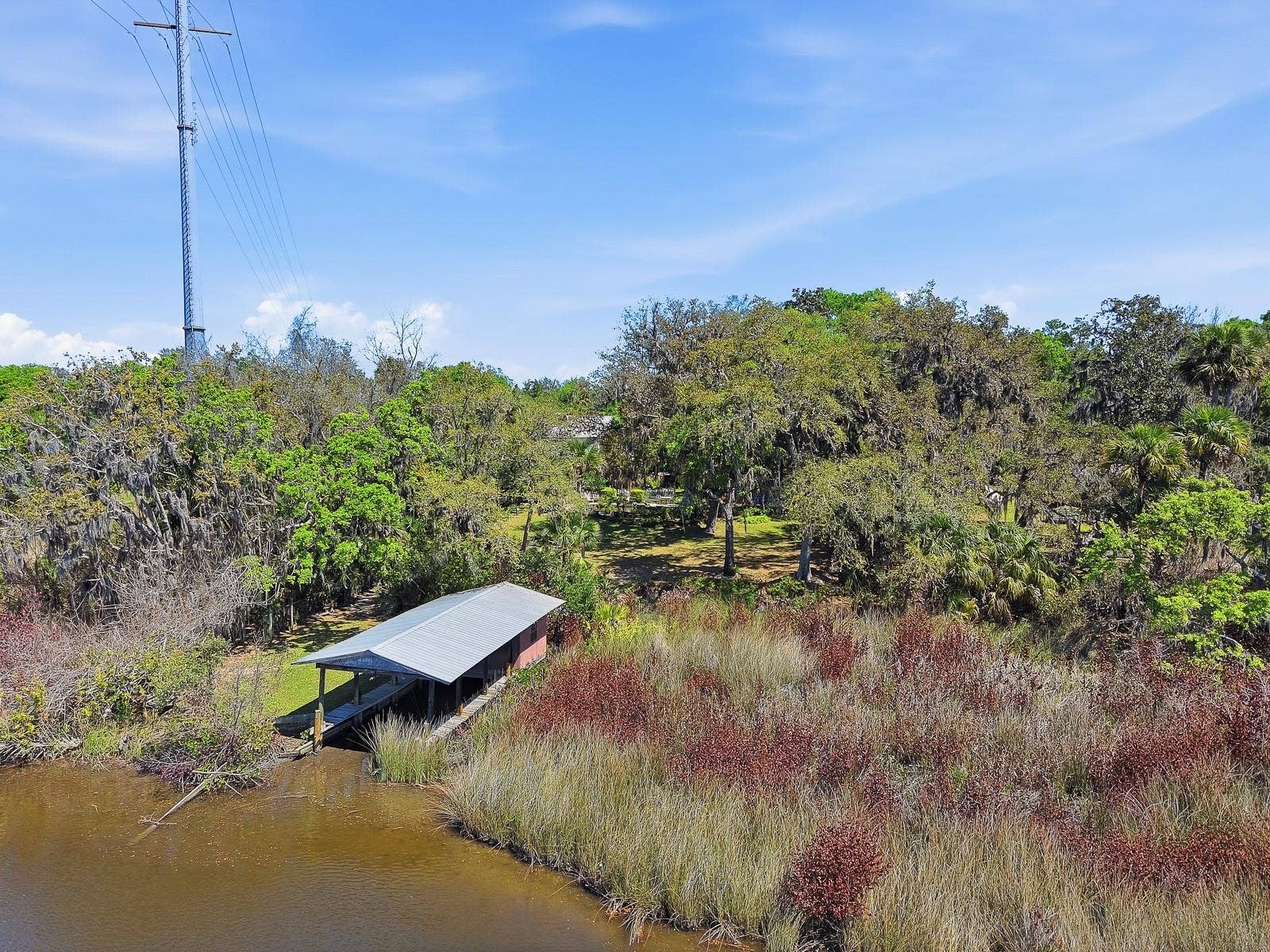 6491 SPRUCE CREEK ROAD, Port Orange, FL 32127 Boathouse with lift, electric and water!