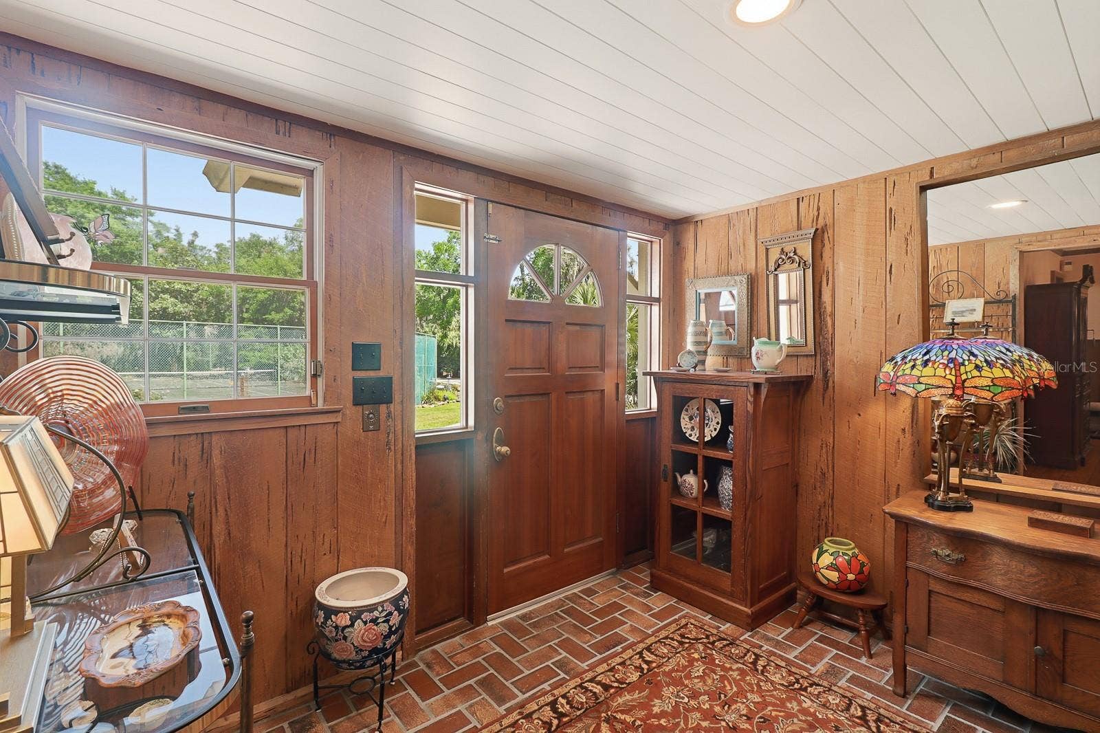 6491 SPRUCE CREEK ROAD, Port Orange, FL 32127 Foyer with authentic cypress walls and brick floors