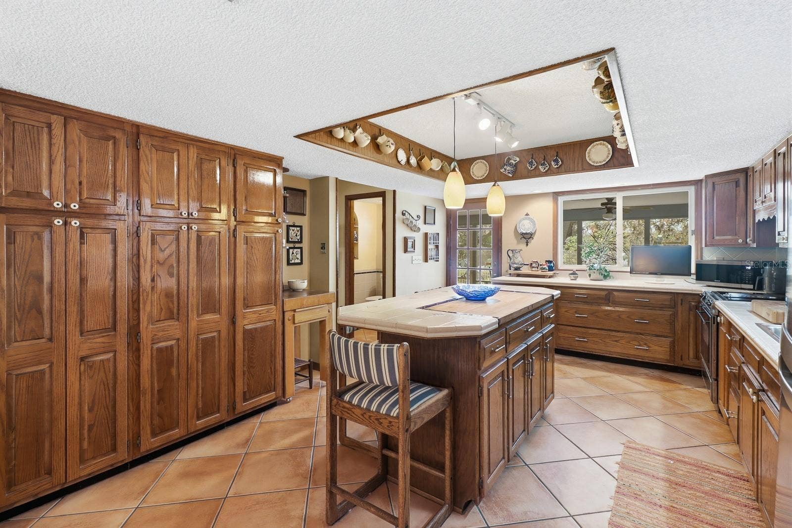 6491 SPRUCE CREEK ROAD, Port Orange, FL 32127 Timeless wood cabinetry with built in butcher block.