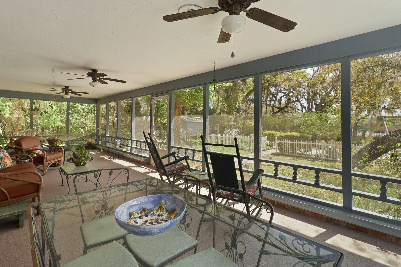 6491 SPRUCE CREEK ROAD, Port Orange, FL 32127 Expansive back porch overlooking the gardens
