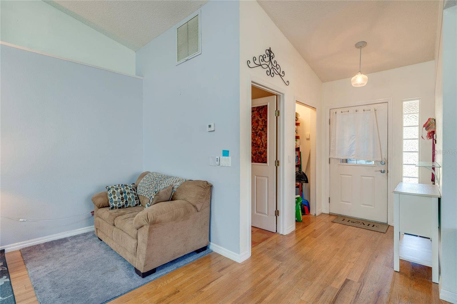 1312 N WEMBLEY CIRCLE, Port Orange, FL 32128 Living room on the left, entry on the right