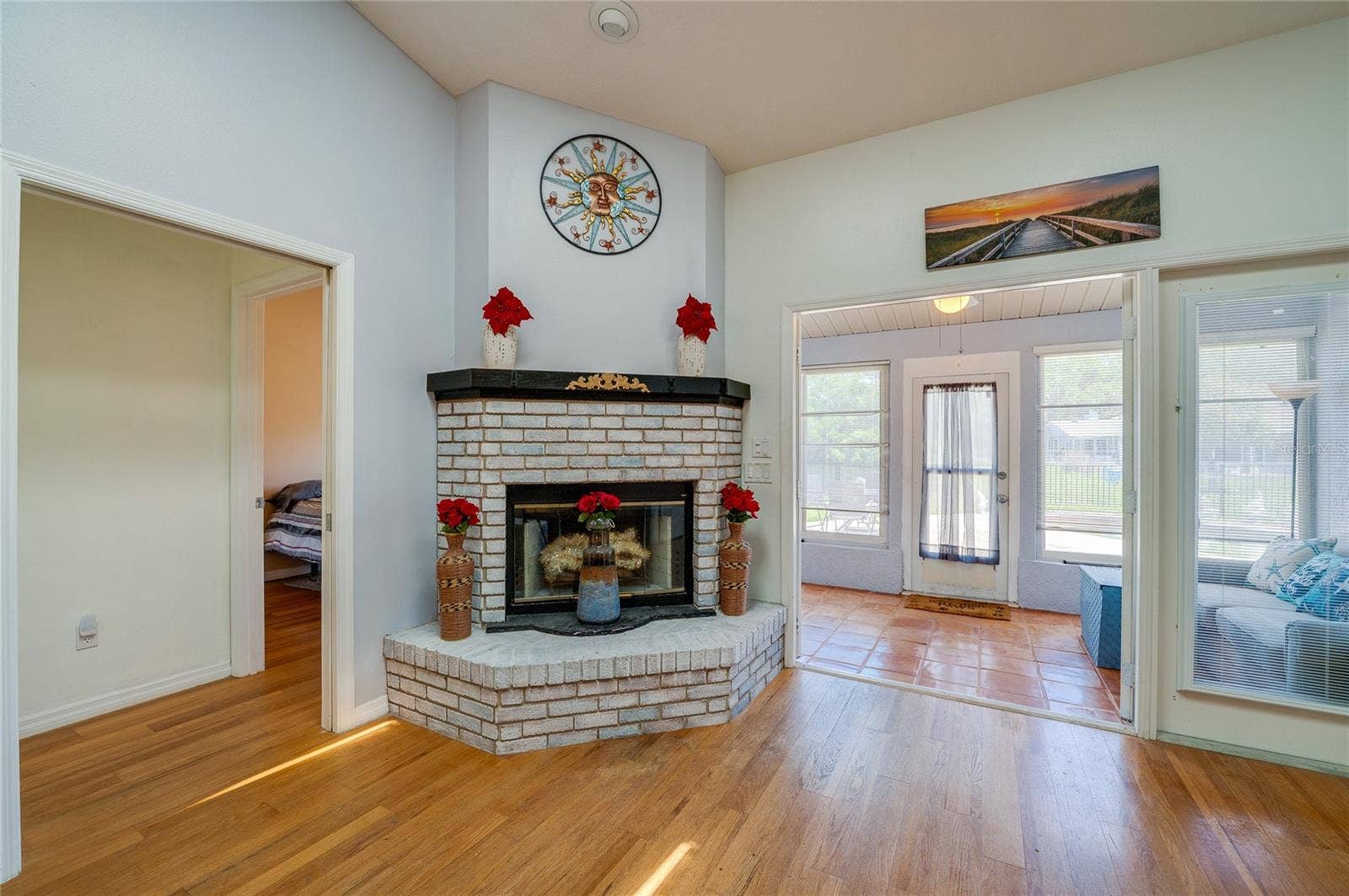 1312 N WEMBLEY CIRCLE, Port Orange, FL 32128 Wood-burning fireplace, French doors open to Florida room