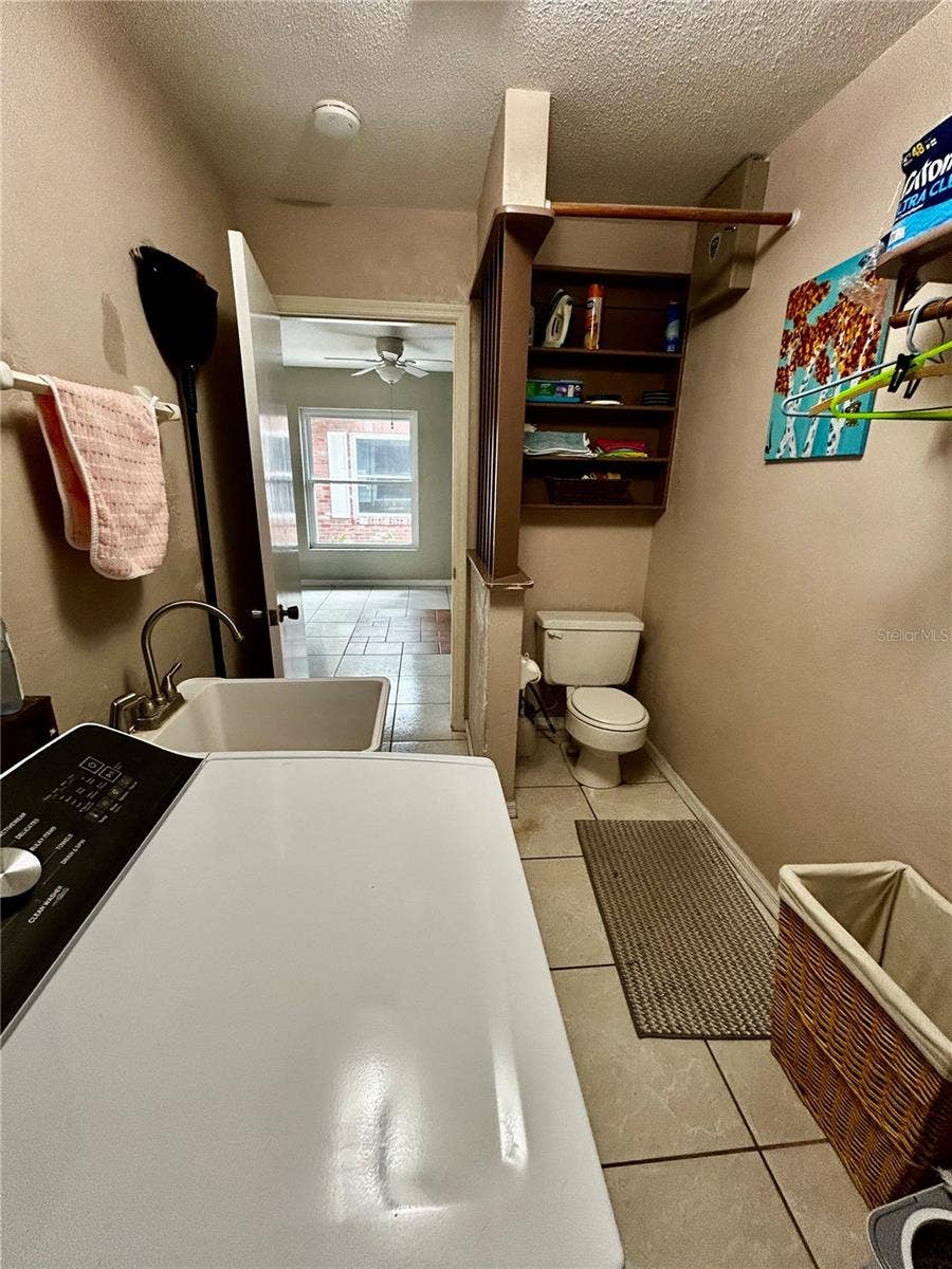 2950 N SHELL ROAD, Deland, FL 32720 laundry with utility sink and toilet