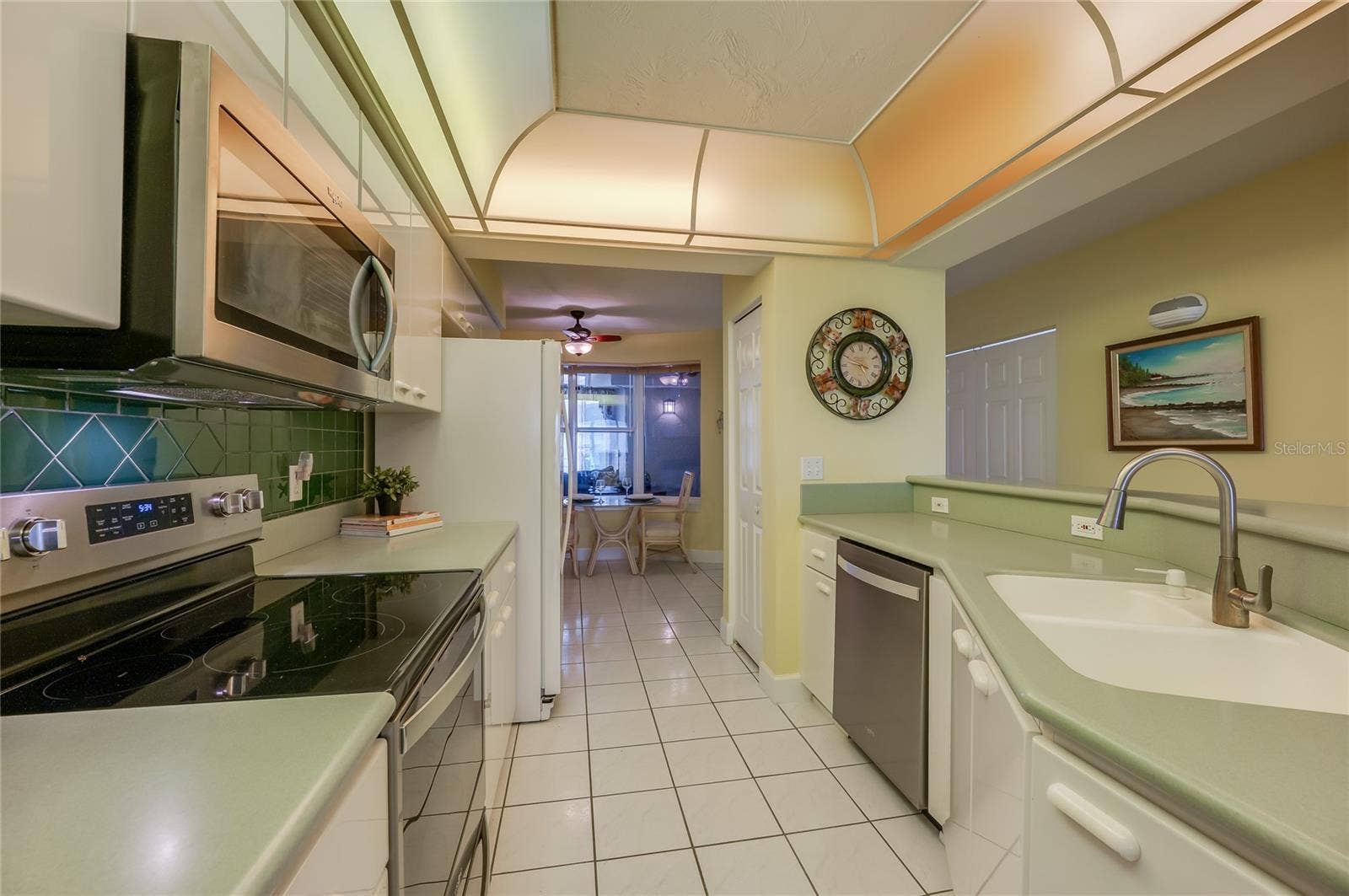 4575 S ATLANTIC AVENUE, #6101, Port Orange, FL 32127 This perspective highlights the open design and sink area, allowing for easy interaction between the kitchen and living/dining spaces.