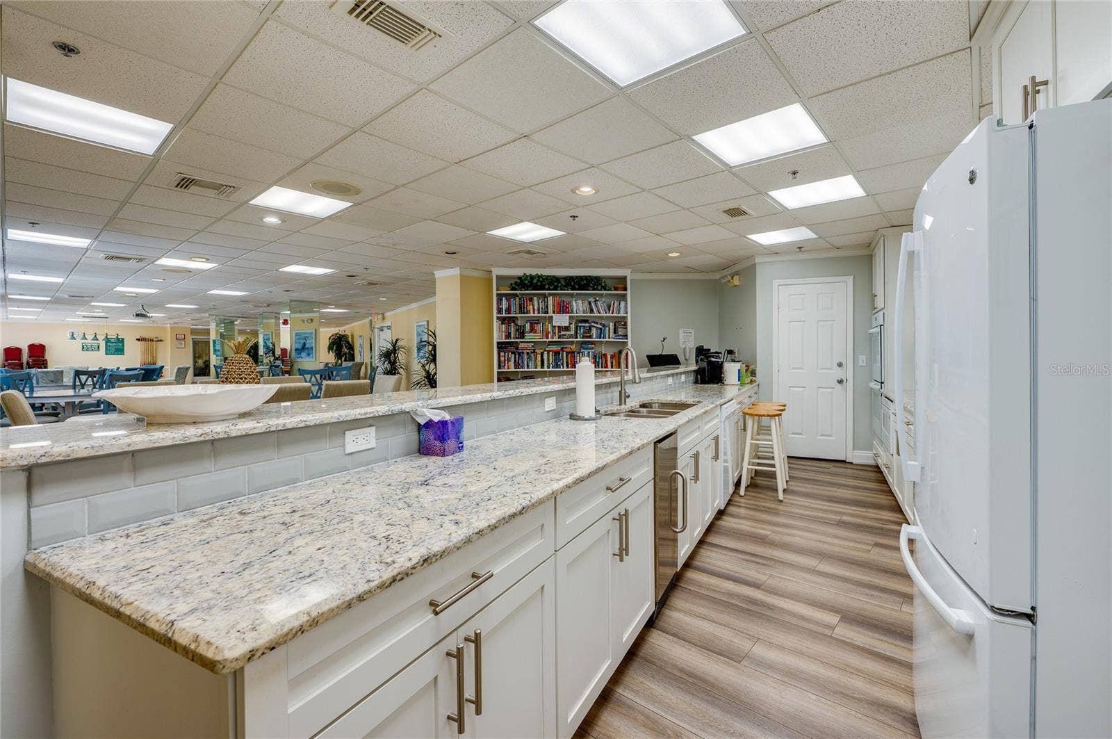 4575 S ATLANTIC AVENUE, #6101, Port Orange, FL 32127 Well-appointed kitchen featuring granite countertops, generous cabinetry, and bar seating for added convenience.