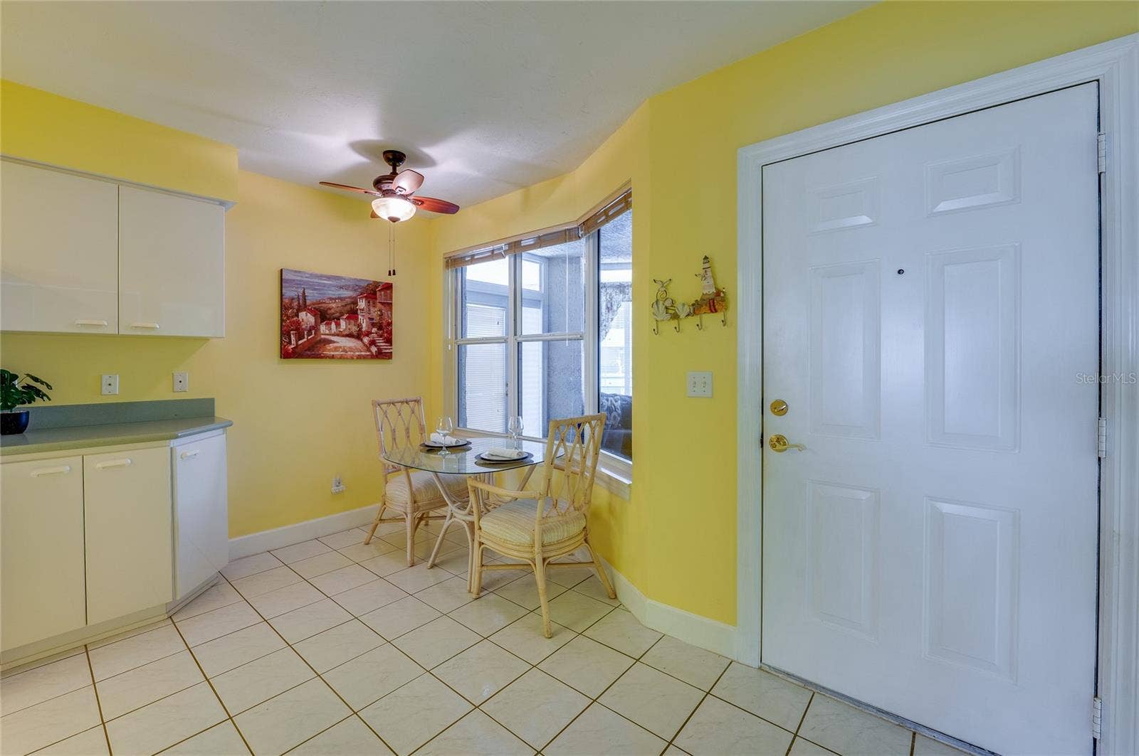 4575 S ATLANTIC AVENUE, #6101, Port Orange, FL 32127 A charming breakfast area with large windows provides a bright setting for casual dining, enhanced by natural light and easy access to the kitchen.
